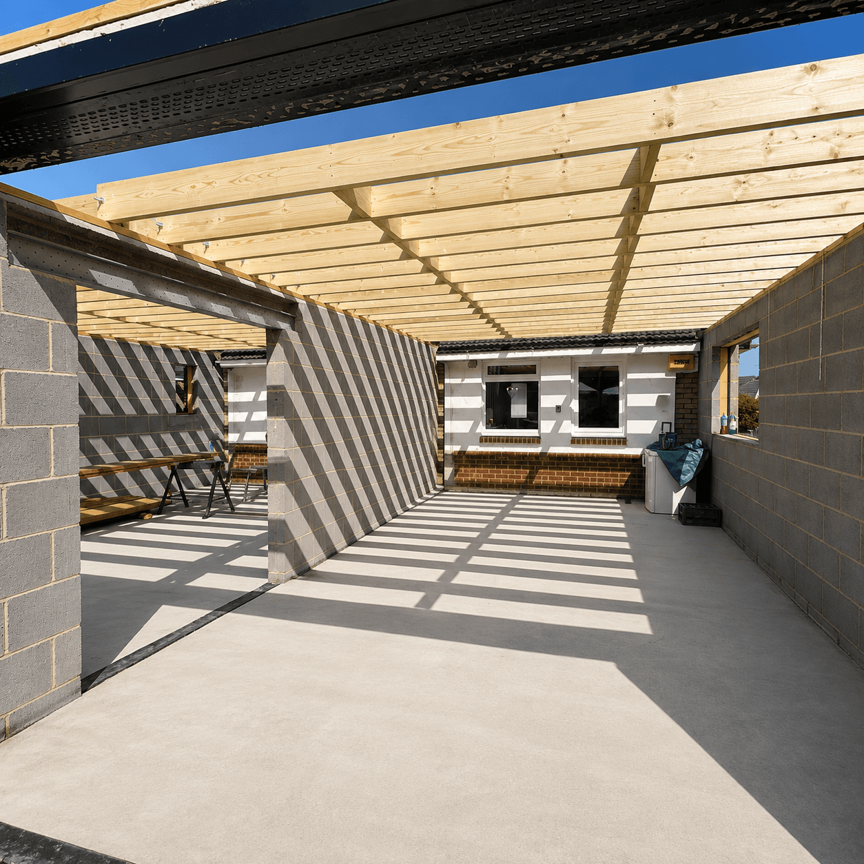 Extension under construction: blockwork walls, steels and new flat-roof joists